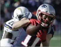  ?? CHARLES KRUPA - THE ASSOCIATED PRESS ?? New England Patriots wide receiver Julian Edelman (11) catches a pass in front of Los Angeles Chargers defensive back Desmond King during the first half of an NFL divisional playoff football game, Sunday, Jan. 13, 2019, in Foxborough, Mass.