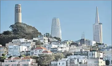  ?? Photograph­s by Josh Edelson For The Times ?? THE NEW $1-billion, 1,070-foot Salesforce Tower, above between Coit Tower and the TransAmeri­ca Pyramid as seen from Fisherman’s Wharf in San Francisco. Salesforce Tower’s foundation is firmly inside bedrock.