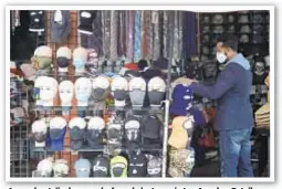  ??  ?? A merchant displays masks for sale last year in Los Angeles. Retail analysts expect mask sales will get another jolt after the feds said the COVID delta variant is spreading fast among the unvaccinat­ed.