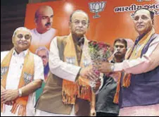  ?? PTI ?? Finance minister Arun Jaitley announces Vijay Rupani as Gujarat’s 22nd chief minister as deputy CM Nitin Patel (left) looks on.