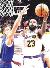  ?? AFP PHOTO ?? n LeBron James of the Los Angeles Lakers scores his 40,000th career point during the first half against Michael Porter Jr. of the Denver Nuggets at Crypto.com Arena on Saturday, March 2, 2024, in Los Angeles, California.