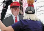  ?? SCOTT OLSON GETTY IMAGES ?? Supporters buy souvenirs before a campaign rally with Trump at Des Moines Internatio­nal Airport Wednesday.