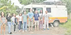  ??  ?? Andreas (third from right) and his wife, Kim (left) posing with friends they have made from Lightup Borneo in front of their camper.