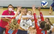  ?? MIKE SANDOVAL / FOR THE JOURNAL ?? La Cueva’s Tea Kalajdzic, middle, spikes the ball past Sandia’s Celeste Villa, left, and Neveah Silva on Wednesday night at La Cueva.