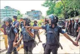 ?? AFP ?? Police stand guard at the scene of an operation in Narayangan­j on Saturday that resulted in the death of three militants.