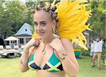  ??  ?? Adele was criticised on social media after posting a photograph of herself in a Jamaican flag bikini with her hair tied in Bantu knots