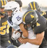  ?? DAVID GARRETT/SPECIAL TO THE MORNING CALL ?? Northweste­rn Lehigh’s Nick Henry (4), seen tackling Salisbury’s Timothy Buda, is a two-way star for the Tigers.