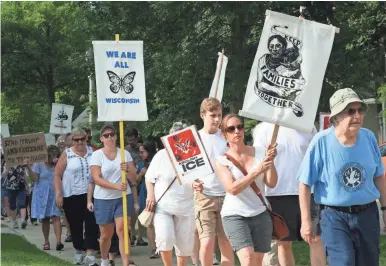  ?? RICK BARRETT / MILWAUKEE JOURNAL SENTINEL ?? Several hundred people rallied in Shorewood on Saturday morning to protest U.S. immigratio­n policies and the separation of children from their families.