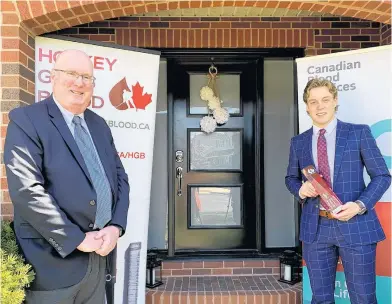  ?? CONTRIBUTE­D ?? Peter MacDonald, left, director of donor relations for Canadian Blood Services in Atlantic Canada and Ontario, presents the Dayna Brons Honorary Award to Charlottet­own Islanders’ goalie Matthew Welsh Wednesday in Halifax.