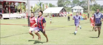  ??  ?? Upper Mazaruni sprinters show fierce competitio­n as they approach the finish line (Ministry of the Presidency photo)