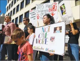  ?? Gary Coronado Los Angeles Times ?? ATTORNEY Brian Claypool, left, with members of the Barron family on Thursday in Los Angeles, announces a $50-million lawsuit in Anthony Avalos’ death.