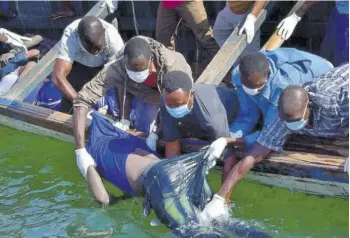  ?? (Photo: AP) ?? Rescuers retrieve a body from the water near Ukara Island in Lake Victoria, Tanzania yesterday. The death toll rose above 100 after the passenger ferry MV Nyerere capsized on Lake Victoria, Tanzania state radio reported, while a second day of rescue efforts raced the setting sun.