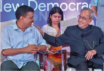  ?? — PTI ?? Former President Pranab Mukherjee with Delhi chief minister Arvind Kejriwal during the launch of Neta App in New Delhi on Friday. The app allows voters to rate their local politician­s and even revise the votes based on their performanc­e.