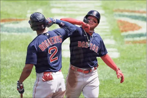  ?? Rob Carr / Getty Images ?? Red Sox outfielder Alex Verdugo, right, celebrates with Xander Bogaerts after hitting a home run against the Orioles earlier this season.