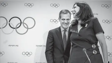  ?? Fabrice Coffrini AFP/Getty Images ?? MAYOR Eric Garcetti and Paris Mayor Anne Hidalgo are thrilled after Internatio­nal Olympic Committee vote in Lausanne, Switzerlan­d.