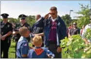  ?? SUBMITTED PHOTO ?? David Cucchi receives a flag for his service to his country from Rainbow Elementary school Boy Scout students. Cucchi is a Homeland Security officer who has dedicated his life to assisting others in need.