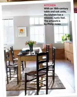  ??  ?? KITCHEN With an 18th-century table and oak units, the kitchen has a relaxed, rustic feel. The artwork is by Philip Jones