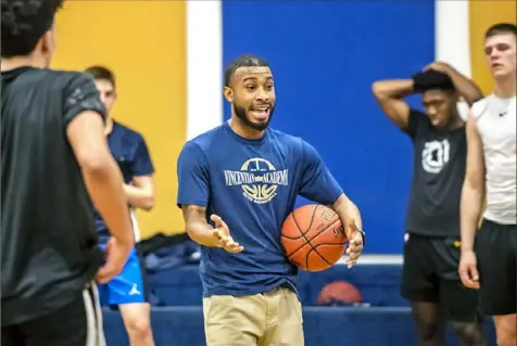  ?? Michael M. Santiago/Post-Gazette ?? Tim Tyree Jr., head coach for Vincentian Academy, gives instructio­ns during practice Wednesday at the school in McCandless.