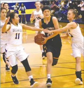  ?? Westside Eagle Observer/MIKE ECKELS ?? Lady Mastiffs Kate Terminella (center) tries to break toward the basket, but Lady Bulldogs Kaylee Morales (11) and Destiny Mejia (3 right) had other ideas during the Decatur-Fayettevil­le Haas Hall conference basketball contest at Peterson Gym in Decatur Dec. 4. Morales and Mejia’s teamwork caused Terminella to miss her layup opportunit­y, thus preserving the Decatur lead.