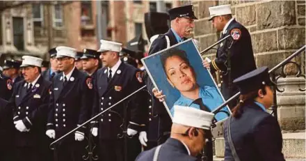  ?? AFP PIC ?? A picture of New York City Fire Department EMT Yadira Arroyo being brought into St Nicholas of Tolentine Church in the Bronx during her funeral on Saturday.