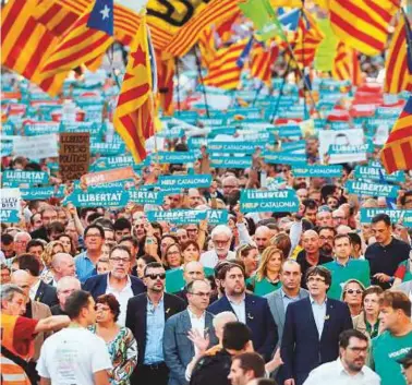  ??  ?? Above: Catalan regional vice-president and chief of Economy and Finance Oriol Junqueras and Puigdemont attend a demonstrat­ion in Barcelona yesterday, to support two detained leaders of Catalan separatist groups.