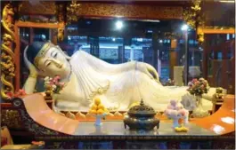  ?? JEROME LEVINE, TRIBUNE NEWS SERVICE ?? A reclining Buddha at Jade Buddha temple in Shanghai.