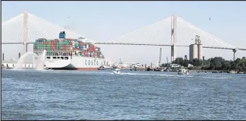  ?? J. SCOTT TRUBEY / STRUBEY@AJC.COM ?? The Cosco Developmen­t, the largest container ship to ever call on an East Coast port, crosses under the Talmadge Memorial Bridge en route to the Garden City Terminal on the Savannah River on May 11.