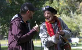  ?? CHRIS YOUNG — THE CANADIAN PRESS VIA AP ?? People smoke cannabis in a Toronto park on Wednesday. Canada became the largest country with a legal national marijuana marketplac­e as sales began early Wednesday.