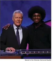  ?? Special to the Arkansas Democrat-Gazette ?? Jeopardy winner Leonard Cooper (right) of Little Rock stands with game show host Alex Trebek. Cooper will return to the show to compete in its first team tournament. Cooper won the teen tournament in 2012.