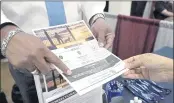  ?? ROGELIO V. SOLIS — THE ASSOCIATED PRESS ?? Curtis McCray, a Mississipp­i Department of Correction­s recruiter, left, points out a positive testimonia­l to a job applicant during the Lee County Area Job Fair in Tupelo, Miss., on Tuesday.