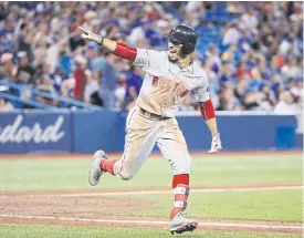  ??  ?? The Red Sox’s Mookie Betts celebrates after completing the cycle in the ninth.