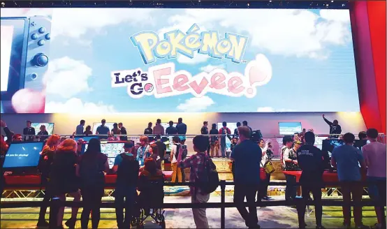  ??  ?? People wait in line to play ‘Pokemon: Let’s Go Eevee’ at the 24th Electronic Entertainm­ent Expo on E3 2018 in Los Angeles, California on June 12, where hardware manufactur­ers, software
developers and the video game industry present their new games....