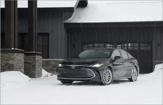  ?? PHOTOS COURTESY TOYOTA ?? The 2021 Toyota Avalon hybrid stands out with its lengthy looks and sharp wheel design.