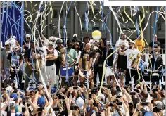  ?? ?? Golden State Warriors’ Andrew Wiggins (top) holds up a Larry O’brien Championsh­iptrophy during the Championsh­ip Parade on Market Street in San Francisco on Monday. Warriors’ Juantoscan­oAnderson (left center) ’ Draymond Green gesture during the parade. Fans arrive for the parade (above).the Warriors pose for a team photo (left)