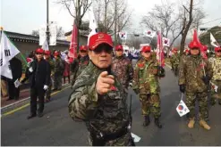  ??  ?? SEOUL: Supporters of South Korea’s President Park Geun-Hye march toward the presidenti­al house during a rally against the impeachmen­t of the president. — AFP