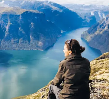  ??  ?? GOLD-TINGED BEAUTY
The view from the mountains above Aurlandsfj­ord, in Norway