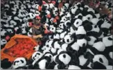  ?? XINHUA ?? An employee arranges stuffed toys that will be exported to Europe and North America at a factory in Lianyungan­g, East China’s Jiangsu province.