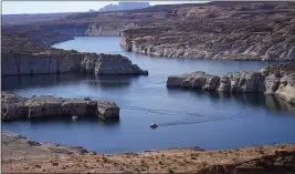  ?? RICK BOWMER — THE ASSOCIATED PRESS FILE ?? A boat cruises along Lake Powell near Page, Ariz.