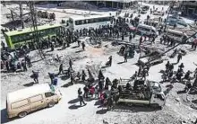  ?? AFP ?? ■ Syrian civilians and rebel fighters prepare to board buses during the evacuation from Arbeen on Sunday.