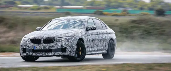  ??  ?? This partially disguised M5 demonstrat­es in testing how the rear-biased AWD will still allow naughty power slides.