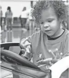  ??  ?? Ava Hooks explores her new car.