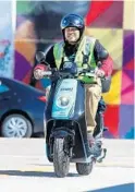  ??  ?? Jerry Chipman, a Revel mechanic/technician, rides one of the company’s electric mopeds in Wynwood.