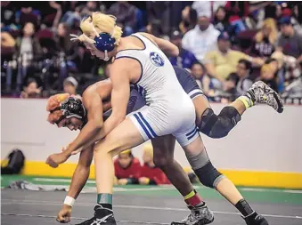  ?? ROBERTO E. ROSALES/JOURNAL ?? Rio Rancho’s Orion Gutierrez, right, takes down Jacob Grobecker of Volcano Vista in the 160-pound state final last weekend. Gutierrez won the match, and the state title at that weight.