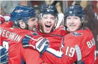  ?? ALEX BRANDON/THE ASSOCIATED PRESS FILE PHOTO ?? John Carlson, centre, will take a shot at a Cup repeat with Alex Ovechkin and Nicklas Backstrom after re-signing for $64 million.