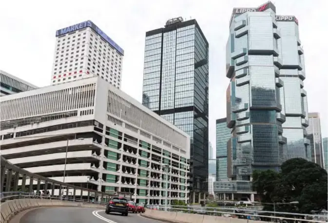  ??  ?? HONG KONG: A general view shows a multi-storey car park, left, in the Central district in Hong Kong. — AFP