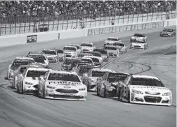  ??  ?? Joey Logano, front left, and Jamie McMurray, front right, lead the pack as they come out of a caution lap Sunday.