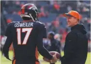  ??  ?? dec. 13:
Osweiler, chatting with Manning before the game, couldn’t rescue the Broncos from a 15-12 loss to the Raiders inDenver. Eric Lutzens, The Denver Post