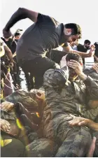  ??  ?? Terrified soldiers surrender to supporters of President Erdogan on Bosphorus Bridge
