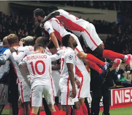  ??  ?? Monaco players celebrate after teammate Valere scored the team’s third goal in Tuesday’s game against Borussia Dortmund Photo: AP