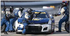  ?? (AP/Matt Kelley) ?? Chase Elliott’s pit crew completes a stop during a NASCAR Cup Series race at Charlotte Motor Speedway earlier this month in Concord, N.C. Conversati­ons regarding the safety of drivers with the Next Gen car and the business model of the series drawing attention away from the playoffs which begins its third round on Sunday.